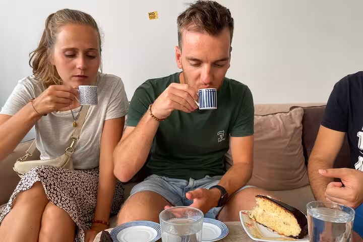 Travelers tasting Turkish coffee with homemade cake in an Istanbul home-hosted coffee cooking workshop