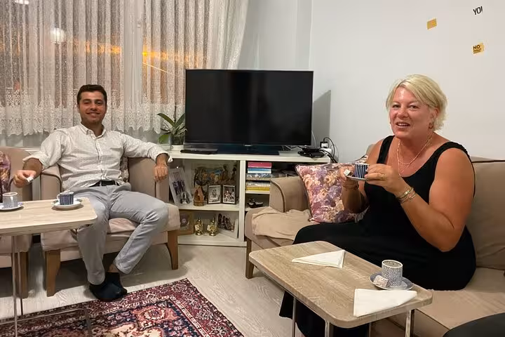 Host and guest enjoying Turkish coffee in a cozy Istanbul living room during a local home tasting tour