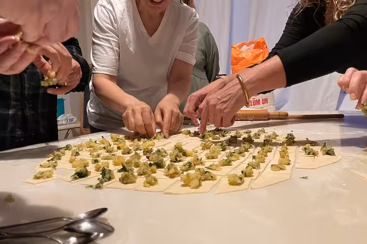 Guests assemble vegan Turkish dumplings on dough squares during an Istanbul home vegetarian cooking class