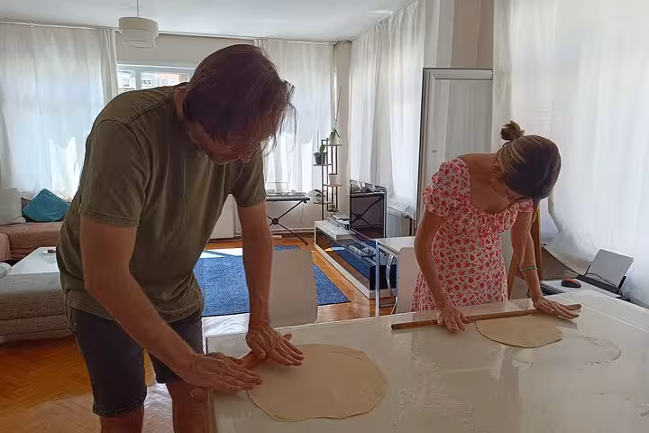 Travelers roll fresh dough with locals in a bright Istanbul apartment for a vegan vegetarian cooking class