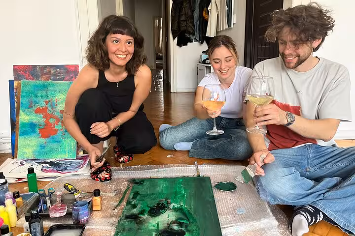 Guests sip wine while painting on canvas at a local home art escape in Istanbul, Turkey