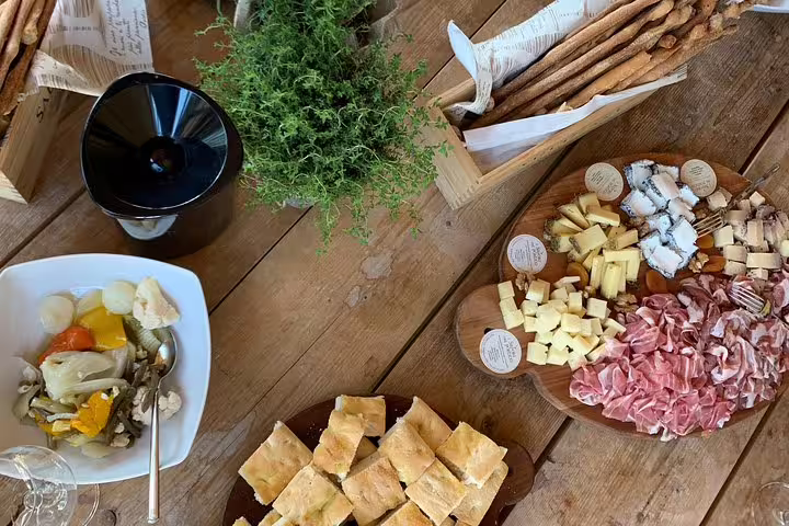 Close-up of a traditional Italian antipasto platter with cheese, cured meats, and fresh bread, perfect for a culinary journey from Venice to Milano.