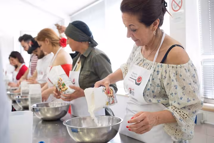 Participants pouring ingredients into bowls at a lively Italian cooking class, enhancing culinary skills.
