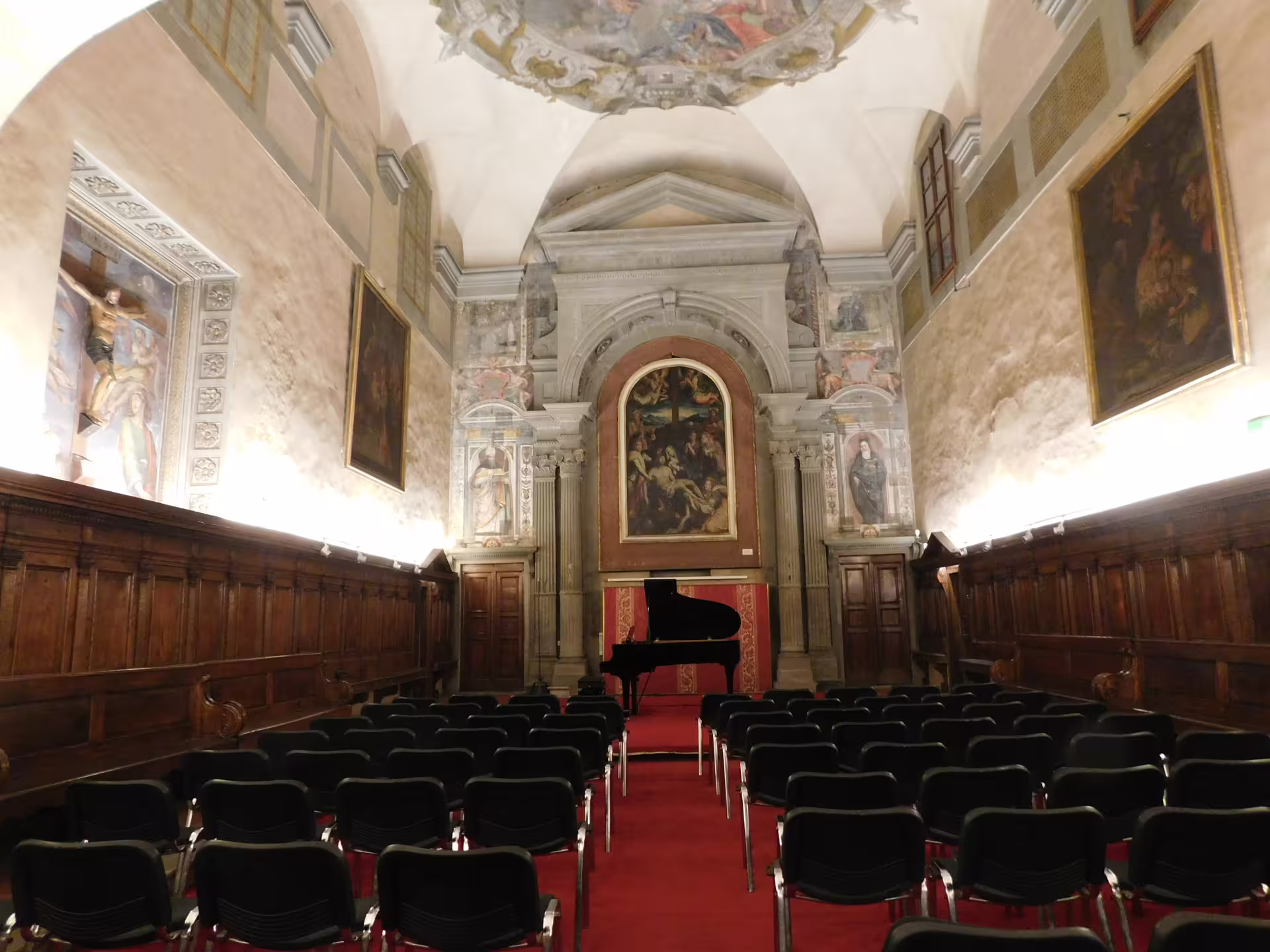 Santa Monaca Church Florence concert hall with grand piano and seating for Italian opera performance