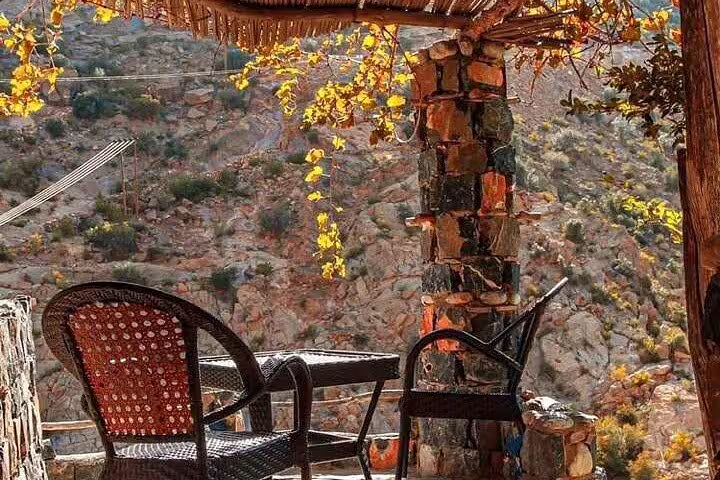 Charming outdoor seating area in Al Suwjara Village overlooking scenic mountain views in Jebel Akhdar.
