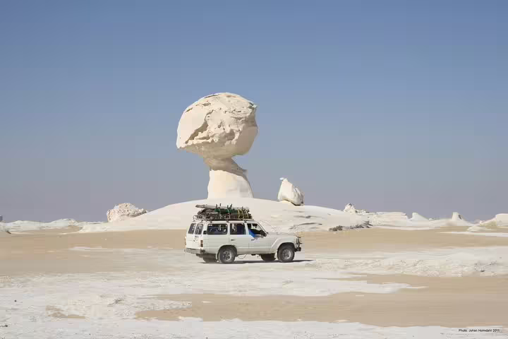 4x4 jeep by Mushroom Rock in White Desert, Egypt, on Bahariya Oasis overnight camping and safari adventure