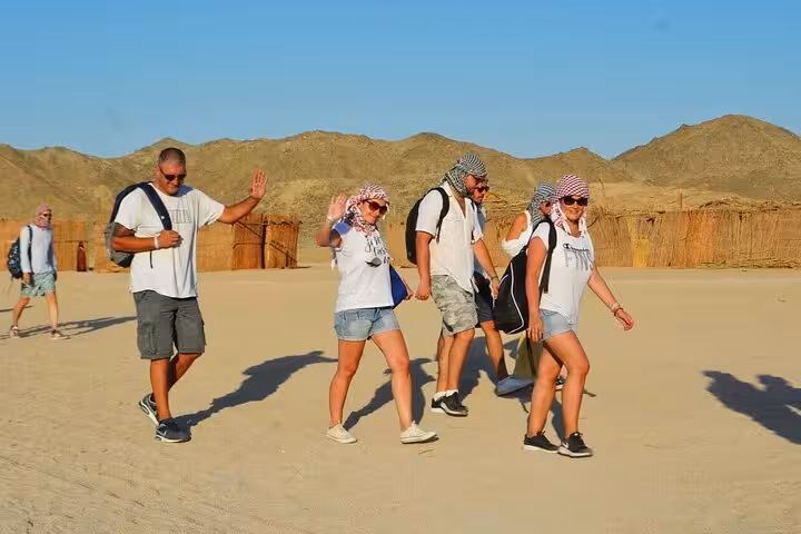Travelers walking in the Eastern Desert on a Mons Claudianus jeep tour to the forgotten Roman quarry site