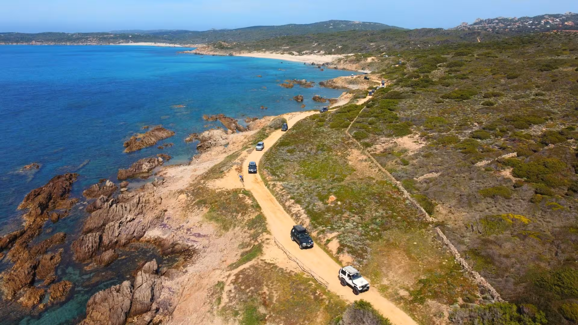 Jeep tour along Sardinia's scenic coast with turquoise waters and rugged cliffs near Mount Limbara.