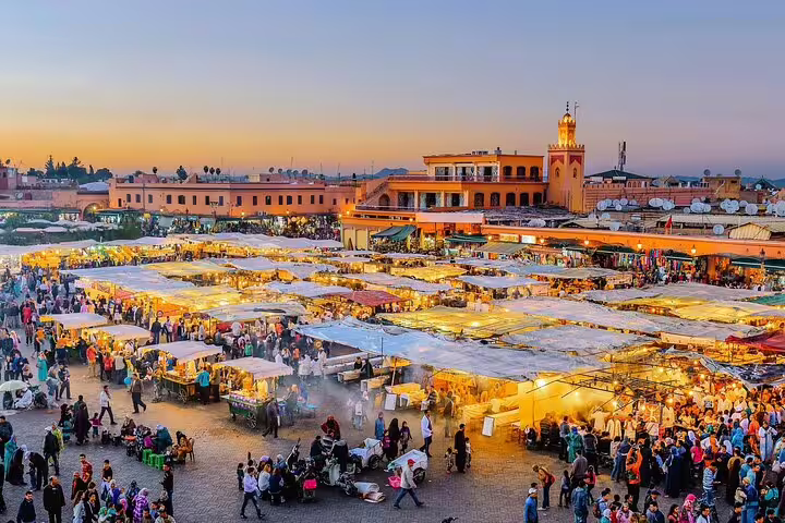 Jemaa el-Fnaa square at sunset in Marrakech, lively night market highlight on Morocco 12 days tour