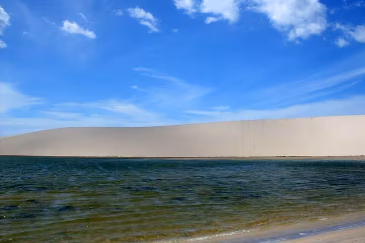 Crystal lagoon beside white sand dunes in Jericoacoara, Brazil, on a 1-day tour adventure