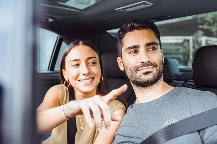 Couple in private car on full-day Jerusalem and Bethlehem tour from Tel Aviv, enjoying door-to-door transfer