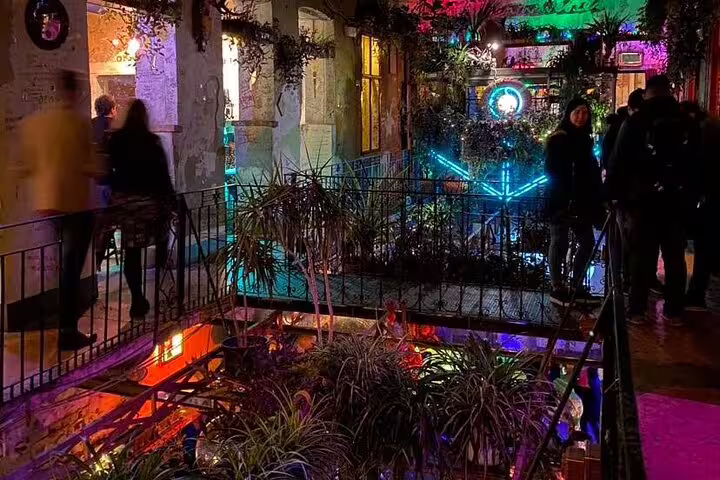 Colorful ruin bar courtyard in Budapest Jewish Quarter, a stop on a private walking tour at night