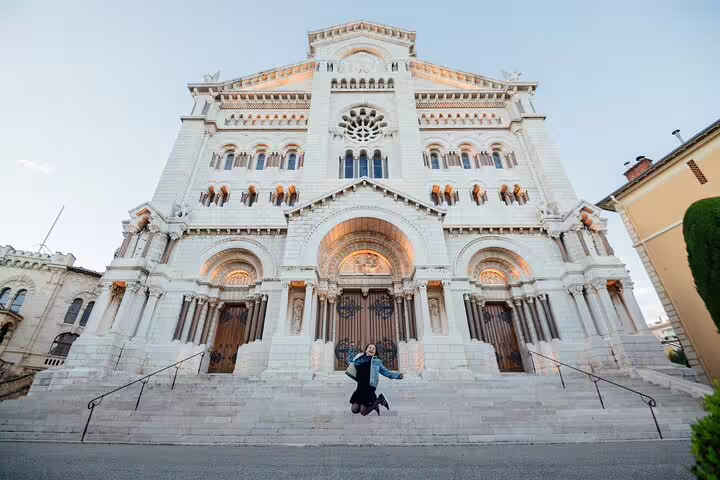 Jumping couple at Monaco Cathedral captured on a private tour with personal travel photographer, iconic backdrop