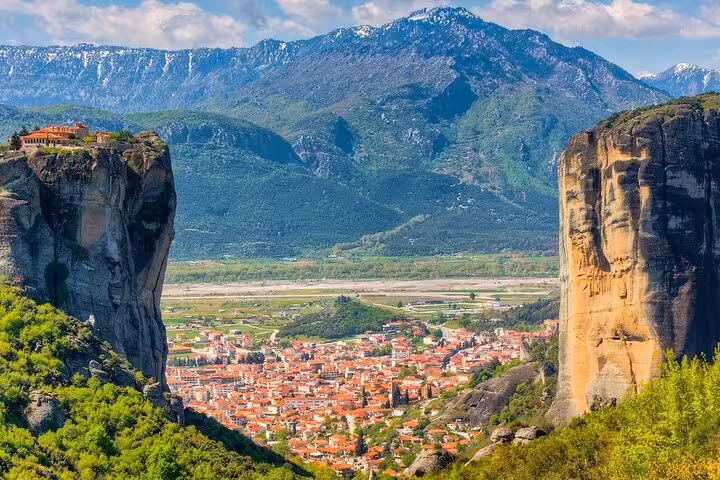 Kalambaka town framed by Meteora rock towers and mountains, scenic stop on a 2-day Delphi and Meteora private tour