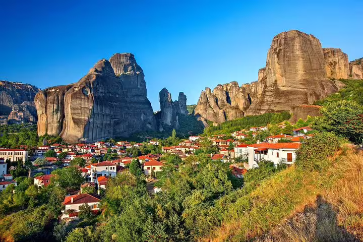 Kalambaka village beneath Meteora cliffs, scenic stop on full-day private tour from Athens with lunch