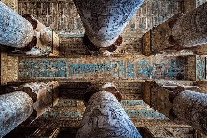 Painted hieroglyph ceiling and massive columns at Karnak Temple, Luxor on Cairo to Luxor overnight flight tour