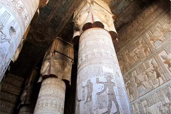 Carved stone pillars and hieroglyphs inside Karnak Temple, Luxor on private overnight tour from Cairo flight