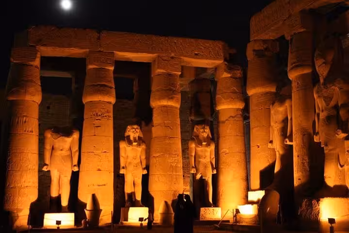 Karnak Temple Light and Sound Show at night with lit pharaoh statues and private transfer in Luxor
