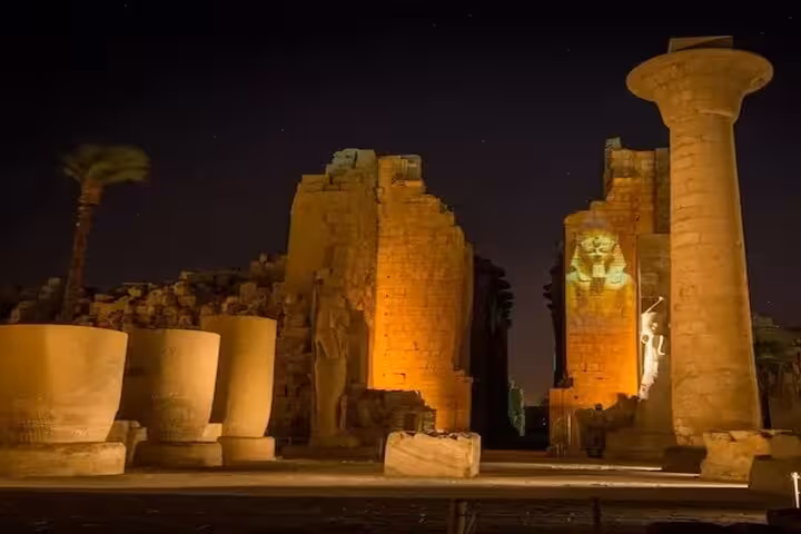 Night view of Karnak Temple ruins lit for the Luxor Light and Sound Show with private transfer service