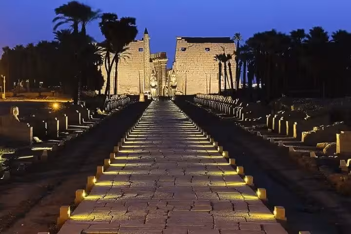 Illuminated avenue to Karnak Temple at dusk during Luxor Light and Sound Show with private transfer