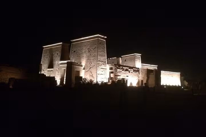 Floodlit Karnak Temple pylons at night on Luxor Light and Sound Show tour with private round-trip transfer