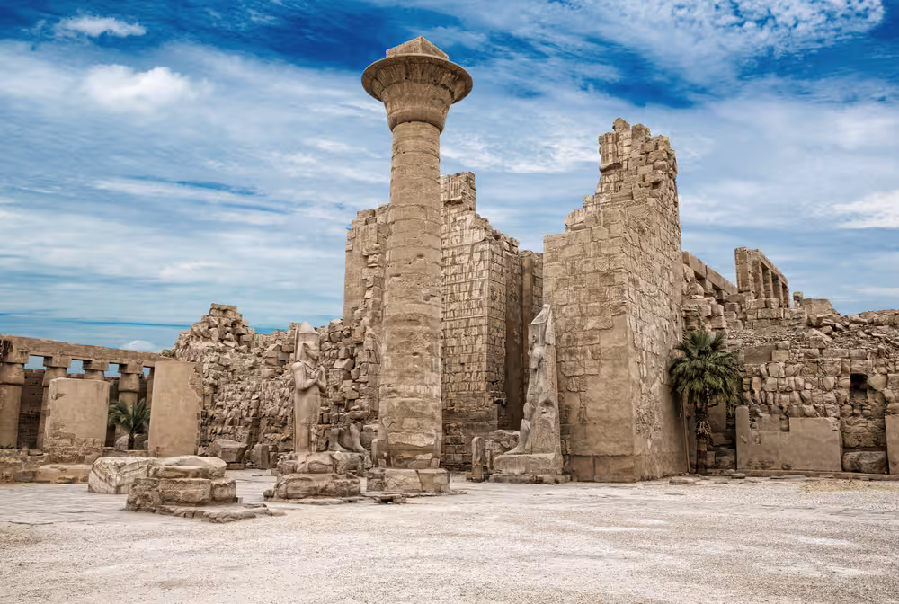 Karnak Temple ruins in Luxor with towering stone column, highlight of 8-day 5-star Pharaoh’s itinerary tour