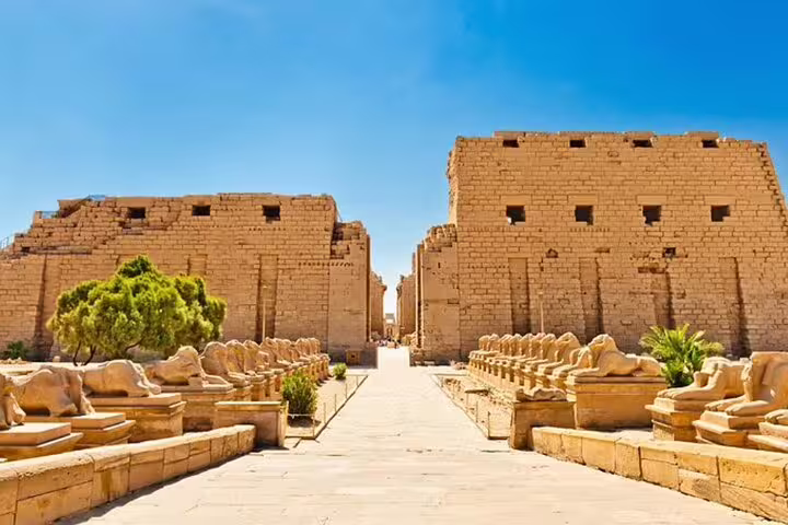 Karnak Temple entrance pathway lined with sphinxes in Luxor, included in Valley of the Kings day trip by bus from Hurghada
