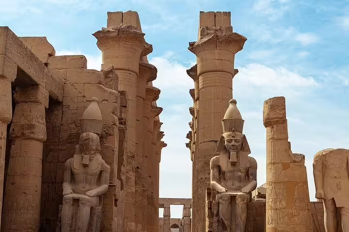 Twin seated statues and ancient pillars at Karnak Temple complex, Luxor historical day tour by bus from Hurghada
