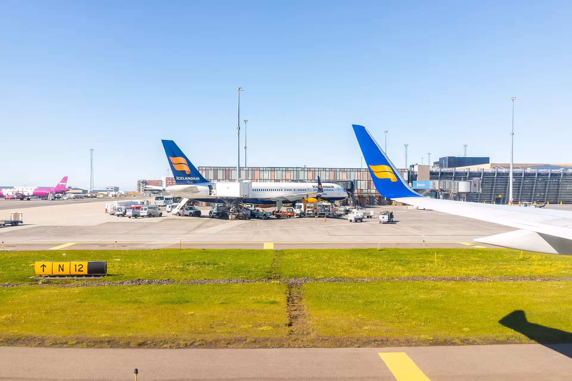 Keflavík International Airport apron with Icelandair planes, ideal for private transfer to Reykjavik hotels