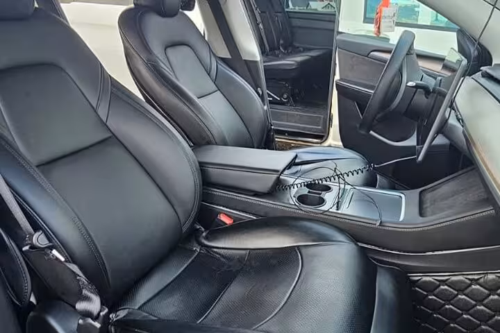 Luxurious black leather interior of a private vehicle for Keflavik Airport transfer service to Reykjavik.