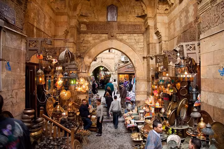 Crowded Khan El Khalili market alley in Islamic Cairo with brass lamps and souvenirs on a Cairo day tour