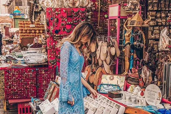 Traveler shopping Khan El Khalili bazaar Cairo, colorful souvenirs on 8-day Luxor Nile cruise and Cairo tour