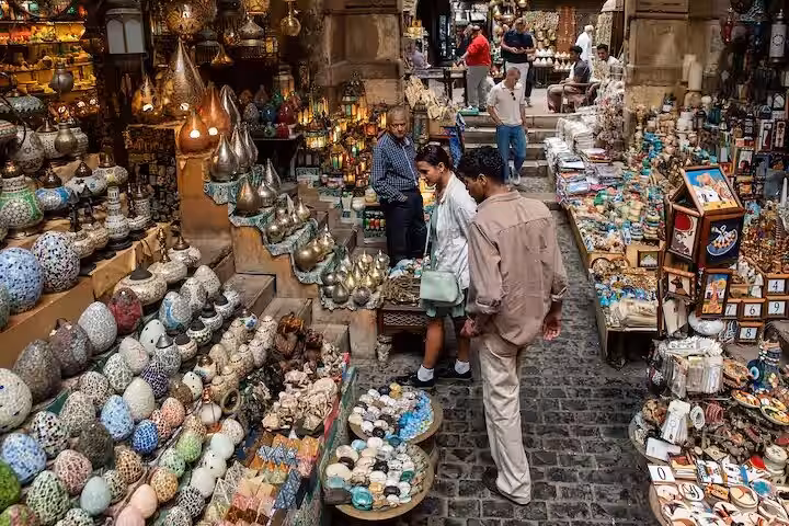 Khan El Khalili bazaar in Cairo with shoppers browsing lanterns and souvenirs on a private guided tour