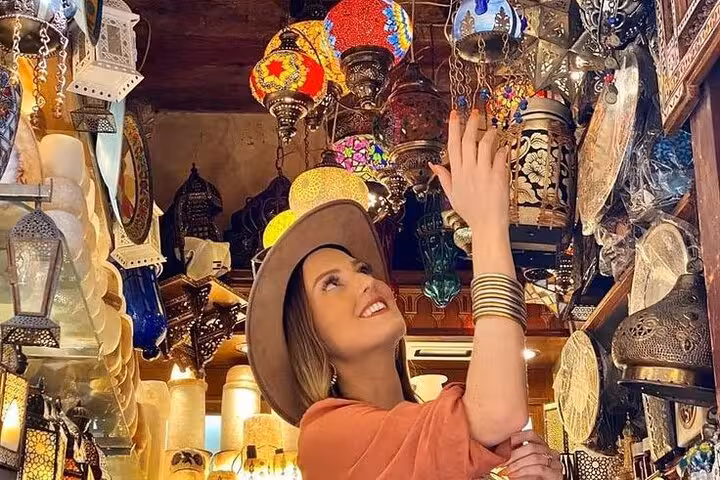 Traveler browsing colorful lanterns in Khan El Khalili bazaar on Cairo Museum Citadel and market tour