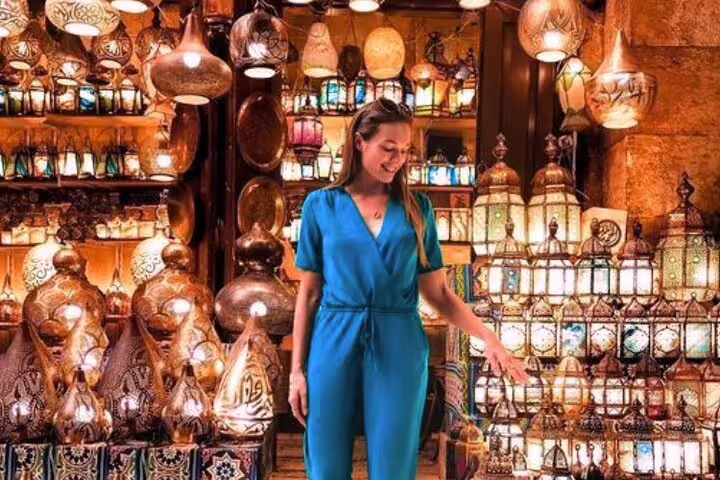 Traveler shopping colorful lanterns at Khan el-Khalili bazaar on 2-day Port Said to Cairo Islamic tour