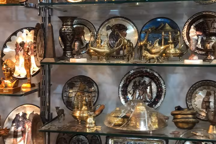 Egyptian souvenirs and brass plates at Khan El Khalili bazaar on private Cairo tour with lunch included