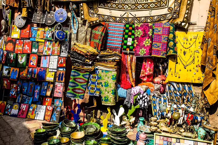 Souvenir stall with textiles, handmade crafts and wall art at Khan El Khalili Bazaar, Old Cairo tour