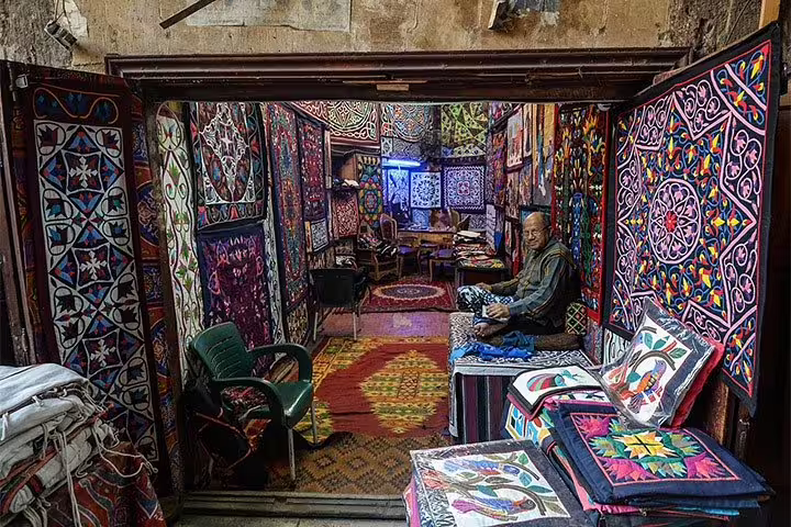 Colorful Khan el-Khalili bazaar textile stall on Cairo tour from National Museum to Citadel and bazaars