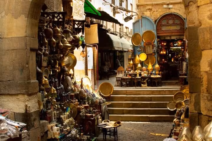 Historic Khan el Khalili alley in Cairo with brassware stalls, part of a private market visit and local dish