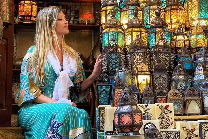 Tourist admiring colorful lanterns at Khan El Khalili market, Old Cairo stop on Egyptian Museum and Citadel tour
