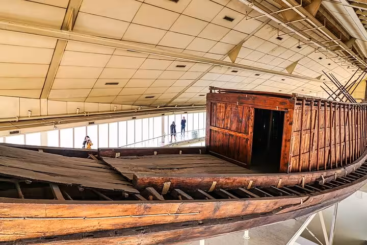 Khufu solar boat at Grand Egyptian Museum Cairo, popular add-on for Fly to Cairo pyramids day tour