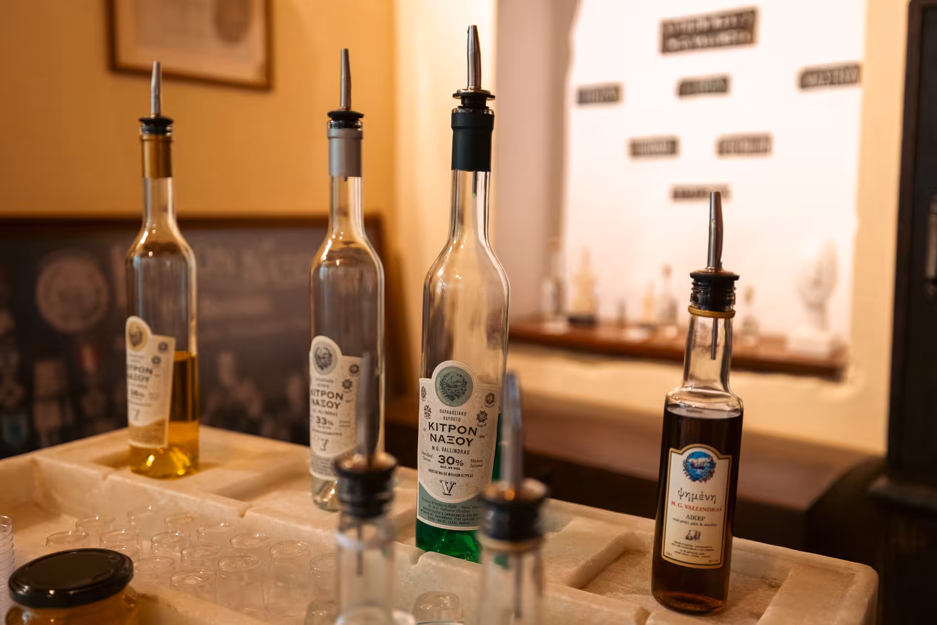 Bottles of Kitron Naxos liqueur at a distillery tasting stop on Foodie’s Favourites Village Tour in Greece