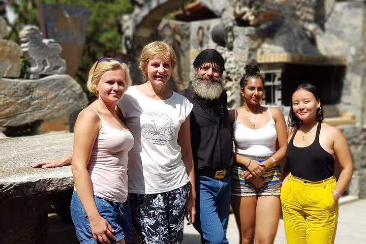 Group of tourists enjoying a guided tour at Knossos Palace, capturing the essence of cultural and historical exploration.