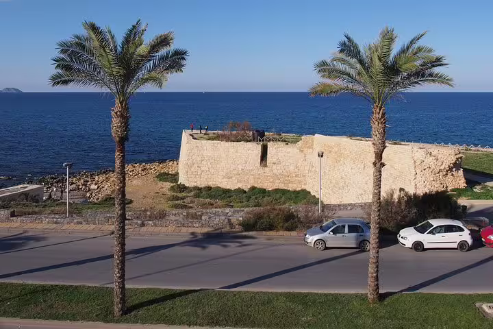 Seafront Venetian fortifications in Heraklion with palm trees, panoramic city tour on Knossos Palace half-day