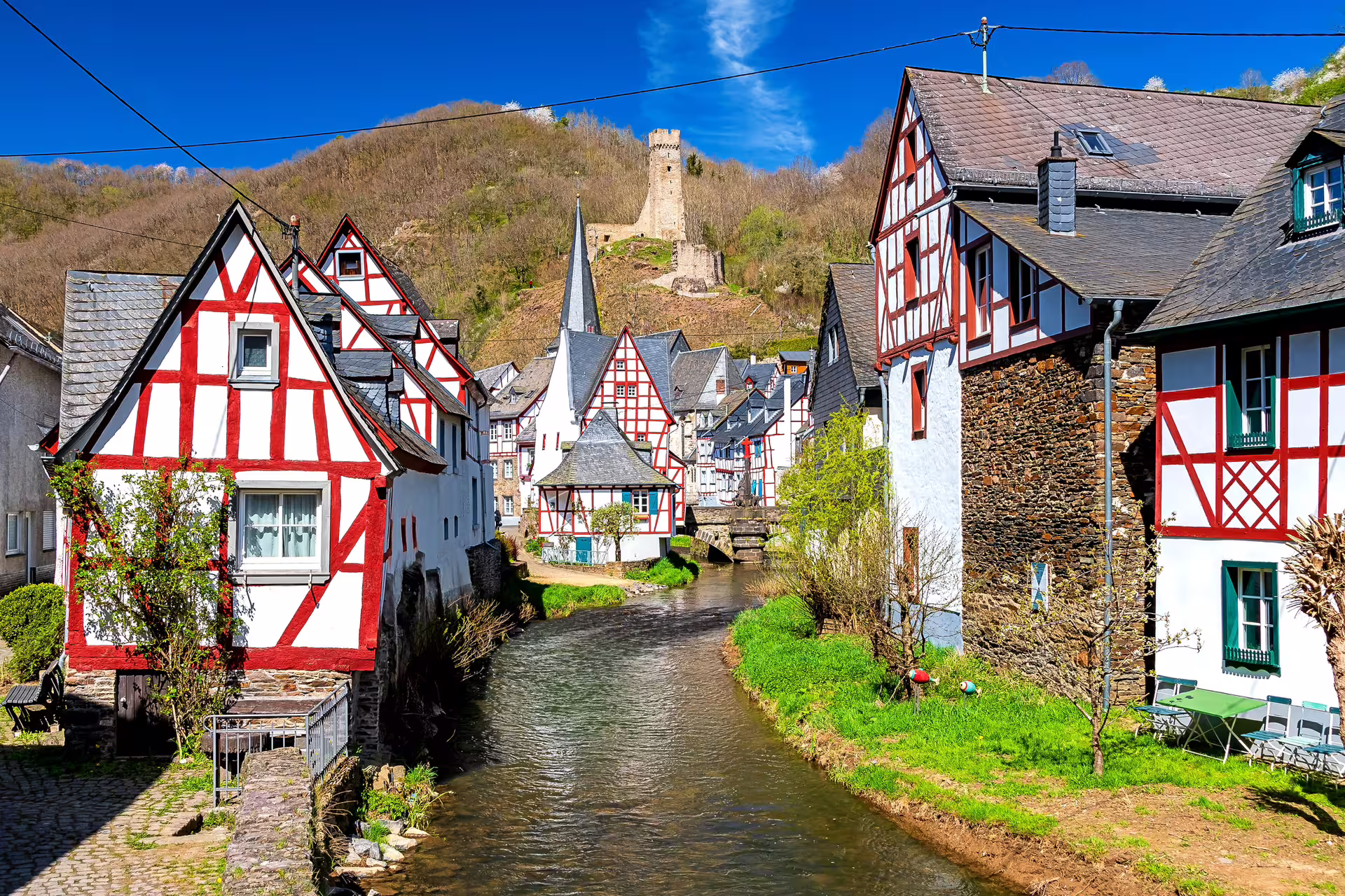 Half-timbered houses by a stream in Koblenz region, perfect for a 1-day walking tour audio guide