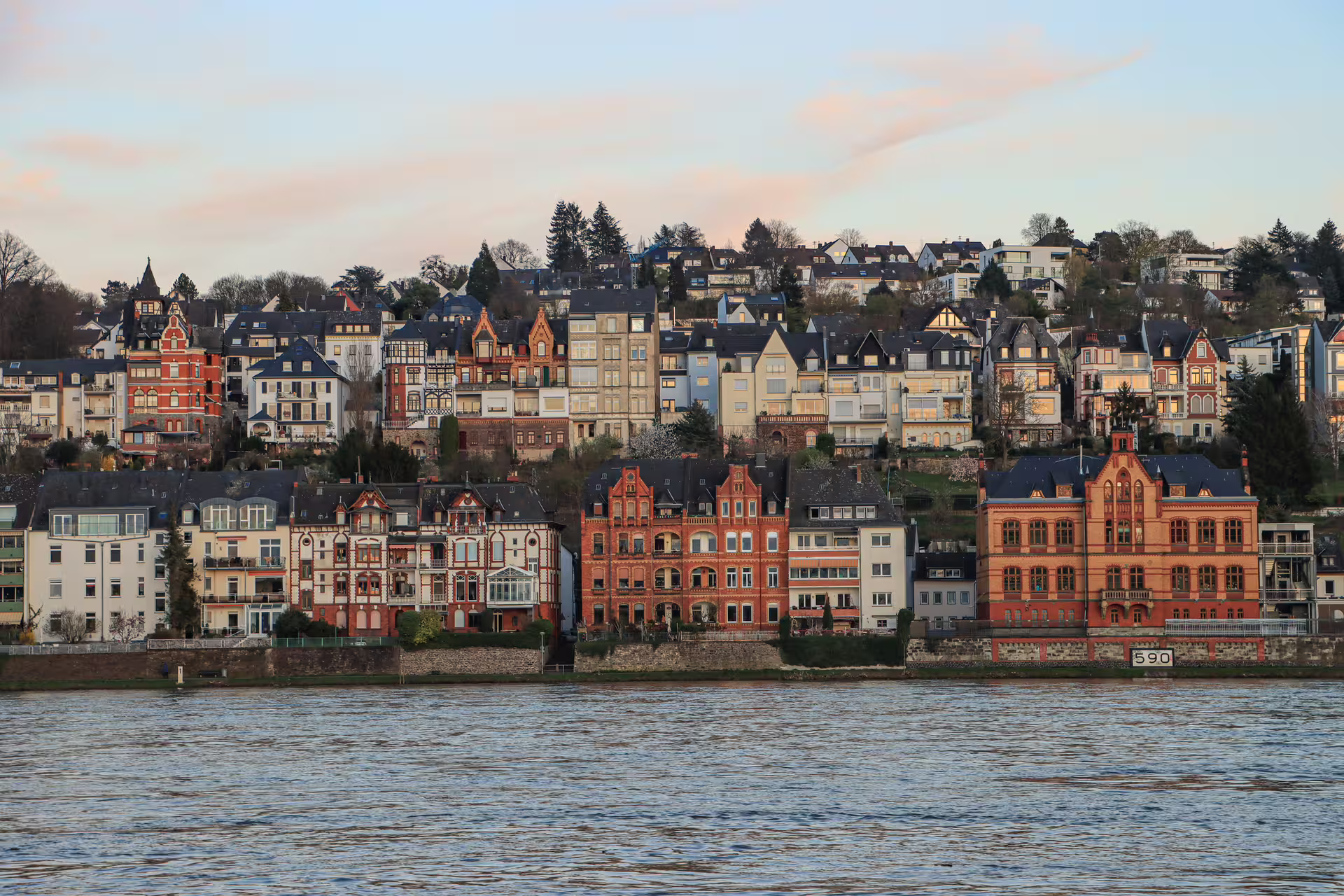 Rhine riverfront villas in Koblenz at sunset, scenic stop on 1-day walking tour with multilingual audioguide