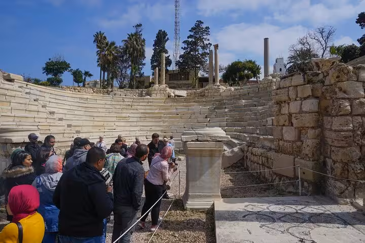 Tour group at Kom El Dikka Roman Amphitheatre ruins on Alexandria day trip from Cairo, Egypt