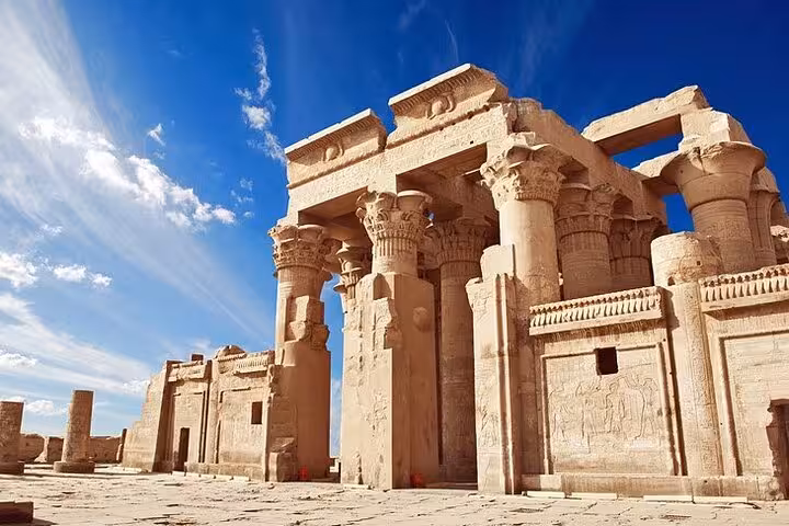 Kom Ombo Temple entrance columns under blue sky, Aswan stop on overnight Abu Simbel from Luxor sightseeing tour