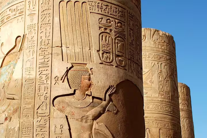 Kom Ombo Temple column with carved pharaoh and hieroglyphs in sunlight, part of Luxor to Edfu and Kom Ombo trip
