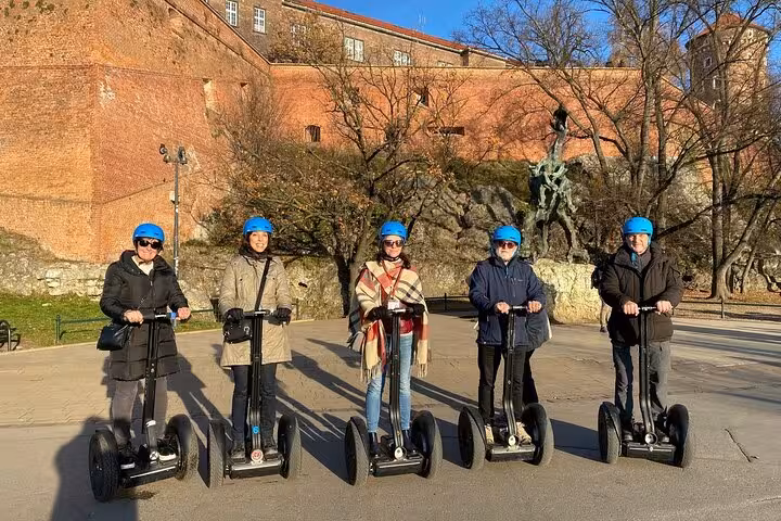 Tourists on Segways exploring the historic Kazimierz district near Wawel Castle in Krakow.